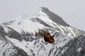 A rescue helicopter from the French Securite Civile flies over the French Alps during a rescue operation next to the crash site of an Airbus A320