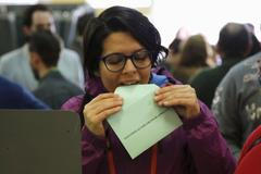 A woman prepares to cast her vote for the Andalusian regional elections at a polling station in in Seville