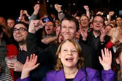 Members of the Social Democratic Party (SPD) react to the first exit polls in a state election in Hamburg