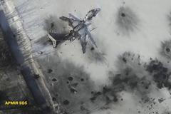 Still image taken from handout aerial footage shot by drone shows outline o airplane in the snow at the Sergey Prokofiev International Airport damaged by shelling during fighting between pro-Russian s