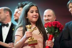 The niece of Iranian film director Panahi appears on stage with jury members and prize winners during awards ceremony at 65th Berlinale International Film Festival in Berlin