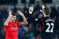 Football: Liverpool's Steven Gerrard and Simon Mignolet celebrate victory