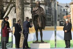Indian actor Amitabh Bachchan , Indian finance minister Shri Arun Jaitley ,Ghandi's grandson Gopalkrishna Gandhi look on as Britain's Prime Minister David Cameron gestures towards a statue of  Mahatma