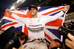 Mercedes Formula One driver Lewis Hamilton of Britain celebrates with his team after winning the Abu Dhabi F1 Grand Prix at the Yas Marina circuit in Abu Dhabi