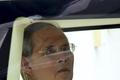 Thailand's King Bhumibol sits in a vehicle as he leaves Siriraj Hospital for the Grand Palace to join a ceremony marking coronation day in Bangkok