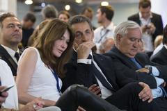 Nicolas Sarkozy, former French president and head of the newly renamed "The Republicans" political party, and his wife Carla Bruni-Sarkozy attend a rally in Paris