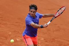 Roger Federer of Switzerland plays a shot to Alejandro Falla of Colombia during their men's singles match at the French Open tennis tournament at the Roland Garros stadium in Paris