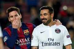 Paris St Germain's Ezequiel Lavezzi walks off the pitch with his compatriot Barcelona's Lionel Messi at the end of their Champions League Group F soccer match at the Nou Camp stadium in Barcelona