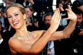 Model Petra Nemcova takes a selfie with a mobile phone as she poses on the red carpet for the screening of the film "Deux jours, une nuit" at the 67th Cannes Film Festival in Cannes