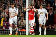 Football: Arsenal's Santi Cazorla looks dejected after missing a chance to score