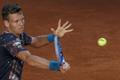 Berdych of the Czech Republic returns a forehand to Isner of the U.S. during their quarterfinal match at the Madrid Open tennis tournament in Madrid