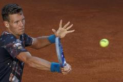 Berdych of the Czech Republic returns a forehand to Isner of the U.S. during their quarterfinal match at the Madrid Open tennis tournament in Madrid