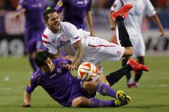 Sevilla's Victor Machin "Vitolo" falls beside Fiorentina's Matias Fernandez during their Europa League semi-final, first leg soccer match at Ramon Sanchez Pizjuan stadium in Seville