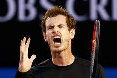 Murray of Britain reacts after hitting a shot against Djokovic of Serbia during their men's singles final match at the Australian Open 2015 tennis tournament in Melbourne