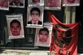 Pictures of the 43 Mexican students who disappeared a year ago are seen hung up near a banner of a revolutionary leader Che Guevara, on the entrance gate of the Mexican embassy in La Paz, Bolivia