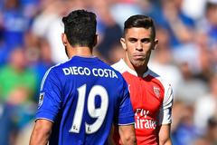 Arsenal's Gabriel Paulista walks past Chelsea's Diego Costa after clashing