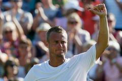 Lleyton Hewitt of Australia gestures to the crowd after losing his match against Jarkko Nieminen of Finland at the Wimbledon Tennis Championships in London