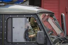 An interior ministry serviceman looks on as he stands at the scene of a shootout near Mukacheve