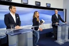 Former Greece's prime minister and leftist Syriza party leader Alexis Tsipras (L) and New Democracy party leader Vangelis Meimarakis stand at their podiums before a televised debate in Athens