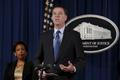 FBI Director James Comey speaks next to U.S. Attorney General Loretta Lynch at a news conference at the Justice Department in Washington
