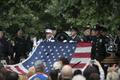 A flag is raised during a ceremony marking the 14th anniversary of the 9/11 attacks, at the National September 11 Memorial and Museum in Lower Manhattan in New York
