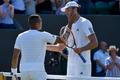 Ivo Karlovic of Croatia meets Jo-Wilfried Tsonga of France at the net after winning their match at the Wimbledon Tennis Championships in London