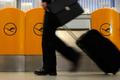 A passenger walks past a ticket counter of German air carrier Lufthansa at Berlin Tegel airport