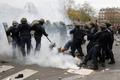 French CRS riot police apprehend a demonstrator during clashes near the Place de la Republique after the cancellation of a planned climate march ahead of the World Climate Change Conference 2015 in P