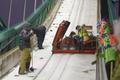 Officials and coaches work hard to freeze the in-run track of the ski jump slope ahead of a ski jumping competition at the FIS World Cup Ruka Nordic 2015 event in Kuusamo
