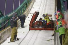 Officials and coaches work hard to freeze the in-run track of the ski jump slope ahead of a ski jumping competition at the FIS World Cup Ruka Nordic 2015 event in Kuusamo