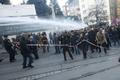 Protesters run from water cannon and tear gas used by riot police to disperse them during a protest in Istanbul