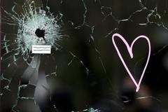 A bullet impact is seen in the window near the Le Carillon restaurant, one of the attack sites in Paris