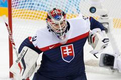 Slovakia's goalie Peter Budaj makes a save against Team USA during their men's preliminary round ice hockey game at the 2014 Sochi Winter Olympics