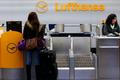 A passenger asks for information at a closed gate of German air carrier Lufthansa at Berlin Tegel airport