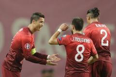 Portugal's Moutinho celebrates his goal against Denmark with his teammate Alves and Ronaldo during their Euro 2016 qualifying soccer match at Municipal Stadium in Braga