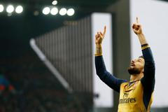 Olivier Giroud celebrates after scoring the first goal for Arsenal from the penalty spot