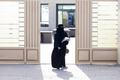 Woman leaves a polling station after casting her vote during municipal elections, in Riyadh, Saudi Arabia
