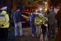 People walk outside a nightclub following an explosion in Bucharest