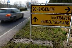 Dopravní cedule s nápisem Schengen, automobil, ilustrační foto