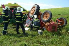 Traktor zavalil na louce řidiče