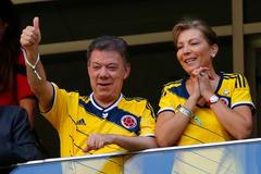 Colombia's President Santos and his wife gesture during the team's 2014 World Cup Group C soccer match against Ivory Coast in Brasilia