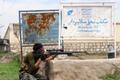 A member of Afghan security force takes his position during a battle with the Taliban on the outskirts of Kunduz province