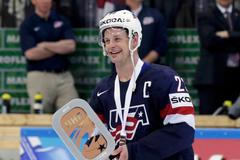Hendricks of the U.S.holds the third place trophy after their Ice Hockey World Championship third-place game against the Czech Republic at the O2 arena in Prague