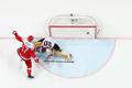 Denmark's Nicklas Jensen scores on his penalty shot against Latvia's goalkeeper Elvis Merzlikins.