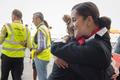 Brusel letiště otevření Brussels Airport staff hug as the first plane takes off from Brussels Airport, which partially re-opened following a bomb blast 12 days ago, in Zaventem
