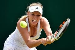 Caroline Wozniacká of Denmark hits a shot during her match against Denisa Allertova of the Czech Republic at the Wimbledon Tennis Championships in London