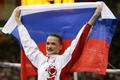Russia's Svetlana Khorkina celebrates with her national flag