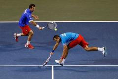 Czech Republic's Stepanek hits a return beside his compatriot Rosol during their Davis Cup quarter-final men's doubles tennis match against Japan's Ito and Uchiyama in Tokyo