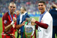 Portugal's Cristiano Ronaldo and Pepe celebrate with the trophy after winning Euro 2016