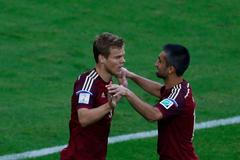 Russia's Kokorin celebrates with Samedov after scoring a goal against Algeria during their 2014 World Cup Group H soccer match at the Baixada arena in Curitiba